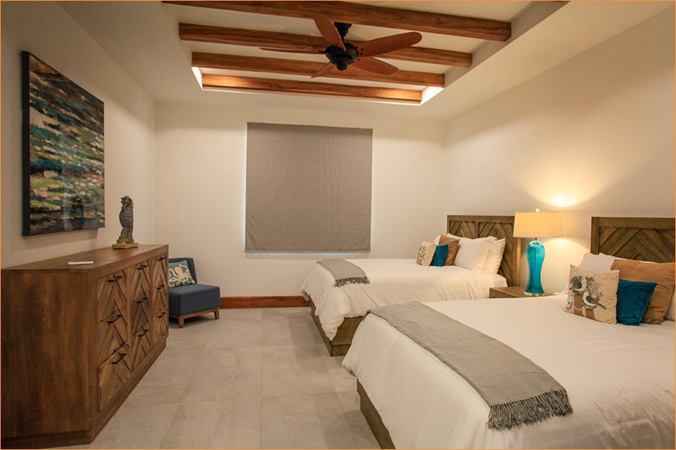 Bedroom number four also features a private bathroom with shower and twin basin sinks.